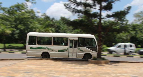 White bus passing a square