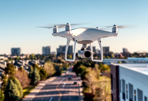 Genre photo: a drone flying in over a city